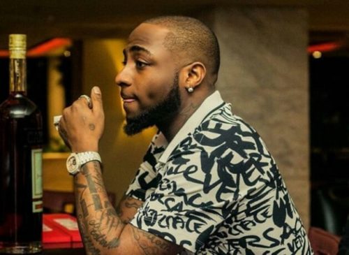 Davido Expresses Shock As Strange Woman Tattoos His Family On Her Back. 54